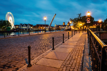Fototapeta na wymiar Beautiful dusk cityscape in Gdansk, view on ambersky wheel and bascule footbridge.