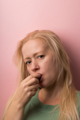  blonde sexually eats plum on a pink background