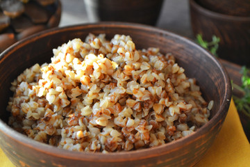 Organic buckwheat porridge in rustic ceramic bowl close up