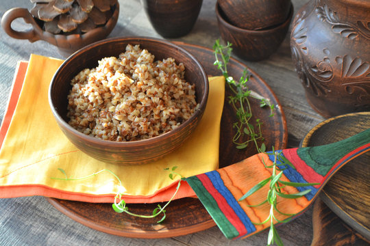 Buckwheat porridge, russian cuisine, bright image with yellow napkin on brown table