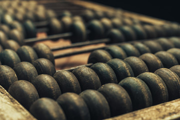 Close up Beautiful old  Vintage wooden  abacus on. red wood table. Macro view.