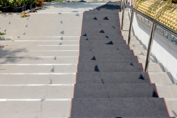 staircase down with black carpet