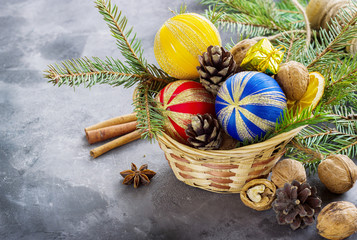 Basket full of Christmas attributes and present boxes on a dark background. Christmas composition