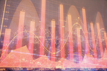 Financial graph on night city scape with tall buildings background double exposure. Analysis concept.