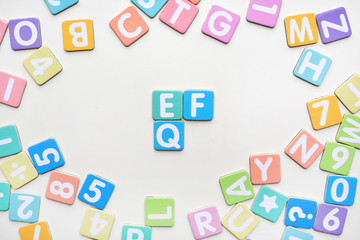 Multi-color Alphabet ABC letters and number and mathematics sign in square flat papers on white background with EF and EQ at center.