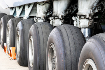 Close up view of a row of tires on the main landing gear of a large transport plane. © VanderWolf Images