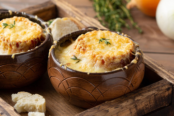 Traditional French onion soup, with croutons, Gruyere cheese, thyme. Tasty cozy, hot, autumn food
