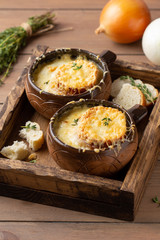 Traditional French onion soup, with croutons, Gruyere cheese, thyme. Tasty cozy, hot, autumn food