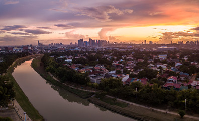Scenic Drone Aerial Picture of the Marikina River and the Skyline of Eastwood City during Sunset in Metro Manila, Philippines
