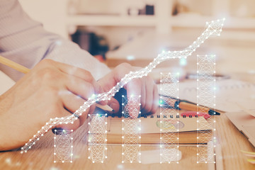 Multi exposure closeup hands with stock market forex graph.