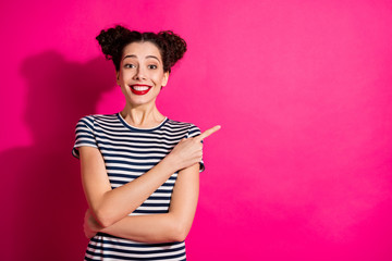 Photo of cheerful curly wavy toothy youngster pointing at empty space with forefinger expressing...