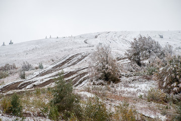 Colorful autumn in the mountains. First snow in october