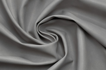 gray artificial leather with waves and folds on PVC base	