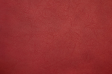 red artificial leather with waves and folds on PVC base	