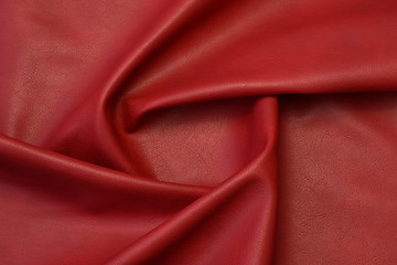 red artificial leather with waves and folds on PVC base	