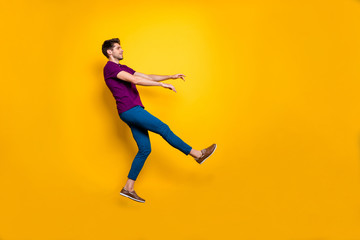 Fototapeta na wymiar Full length body size side profile photo of kicked man having been fired away from job flying back isolated over yellow vivid color background