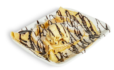 Crepe with ice cream, topping and powdered sugar, on white plate and white background.
