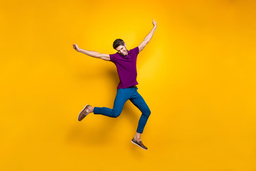 Fototapeta na wymiar Full length body size photo of cheerful positive attrative man in blue pants trousers leather shoes flying jumping running up to his dream isolated over vivid color background