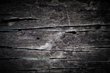 Texture old dark gray wood with scuffs and cracks. Vintage background from old board