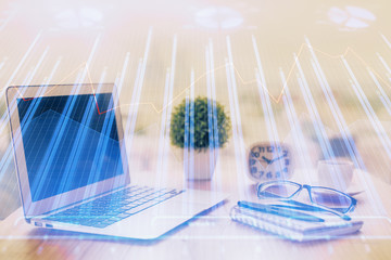 Stock market chart hologram drawn on personal computer background. Double exposure. Concept of...