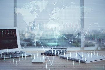 Financial chart drawing and table with computer on background. Multi exposure. Concept of...