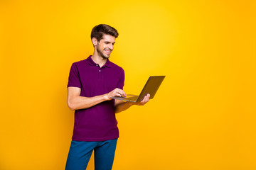 Portrait of his he nice attractive content cheerful cheery guy using laptop working online isolated...
