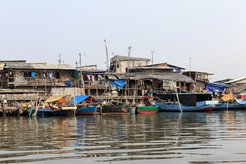 Fototapeta na wymiar Beautiful view of generic homes at the waterfront in the old Sunda Kelapa harbor area in Jakarta, Indonesia