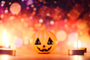 Halloween background candlelight orange decorated holidays festive concept - funny faces jack o lantern pumpkin halloween decorations for party accessories object with candle light bokeh