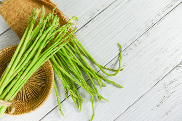 Fresh asparagus bunch on wooden background - Asparagus green in sack for cooking food