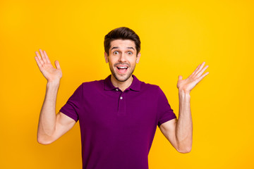 Photo of white cheerful brown haired positive cute nice attractive man expressing astonishment on face unable to believe his eyes isolated over yellow vibrant color background