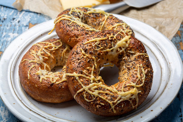 Tasty baked bagels with melted french emmental cheese