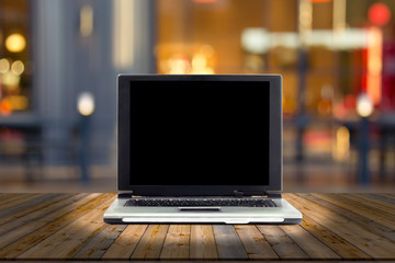 laptops on desk with blur restaurant background,top wooden table
