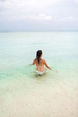 Young woman swimming  in the The Andaman sea in Thailand