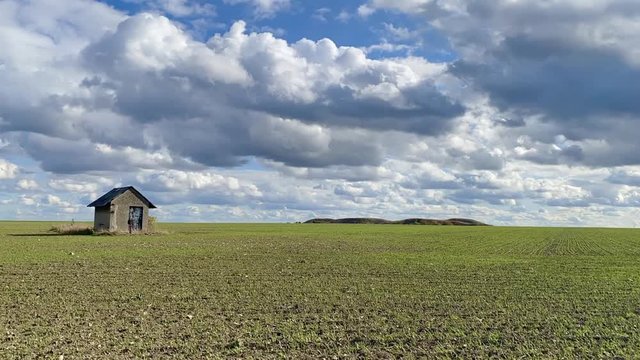 Old barn and empty field after harvesting in sunny day. Panorama picture with mowed wheat field  under  sunny day. Czech Republic