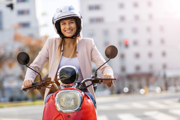 Woman Riding Scooter In The City - obrazy, fototapety, plakaty