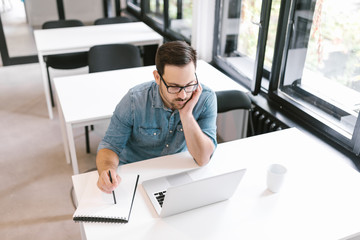 Young handsome man studying.
