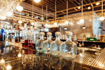 Clean washed and polished glasses hanging over a bar rack