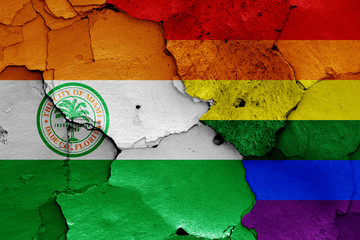 flags of Miami and LGBT painted on cracked wall