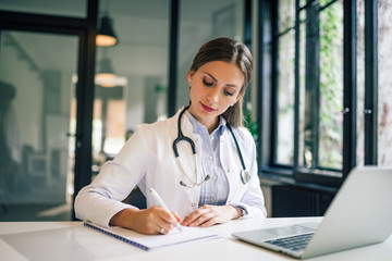 Portrait of a beautiful female doctor working in the office.