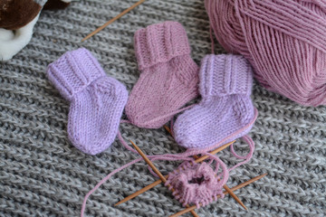 Fototapeta na wymiar Small and cute woolen socks for newborn girl