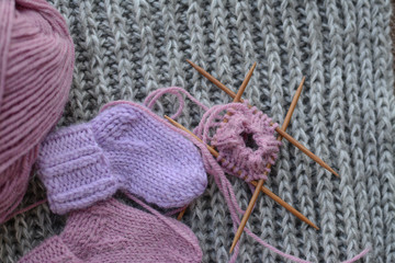 Fototapeta na wymiar Pink and purple baby socks, made of warm and soft woolen yarn