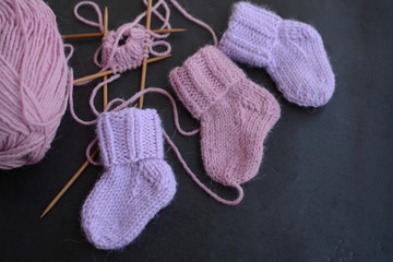 Pink and purple baby socks, made of warm and soft woolen yarn