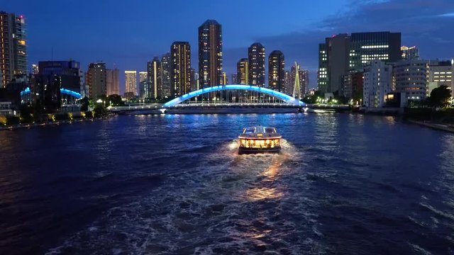 Boat at night cruising down the Sumida river in Tokyo