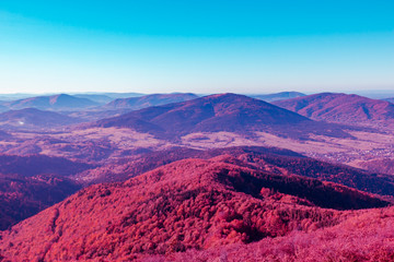 Red purple surreal mountain landscape at the background of azure sky, the concept is amazing and...