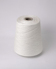 bobbin of yarn on a white background. Side view.Textile reel on isolated white background.