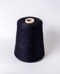 bobbin of yarn on a white background. Side view.Textile reel on isolated white background.