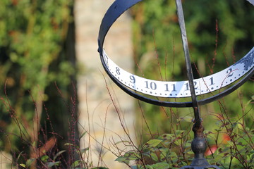 The sundial in the botanical garden. - obrazy, fototapety, plakaty
