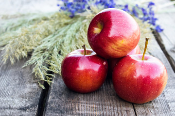 Ripe red apples on a wooden table. Vitamins and a healthy diet. Vegetarian concept.