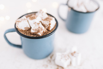 Two cups with cocoa and soft marshmallows