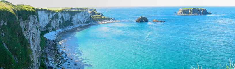 Panorama of Rocky islands on the turquoise ocean, white cliffs of Northern Ireland